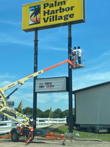 Using a lift to paint tall signposts